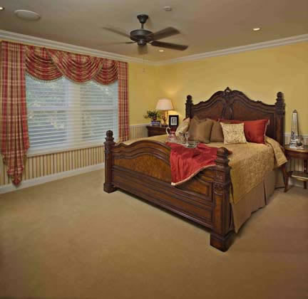 The spacious master bedroom upstairs is decorated in contrasting hues fit for a southern lifestyle.
