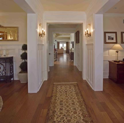 Visitors are immediately transported to a gracious bygone era when they enter the home. The foyer wainscoting is floor-to-ceiling, as well as throughout the upstairs hall. Floors are rich honey butter hickory wood, and lighting is true to the period.