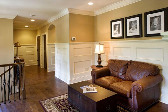 Outstanding in architectural detail, the wide, open second floor hall features a sitting area, wainscoting, arched and paneled door ways and a concealed laundry chute.