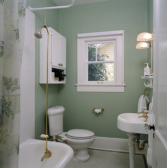 The original bath tub and sink were restored in the existing bathroom. New toilet and fixtures complement the home's original heritage.