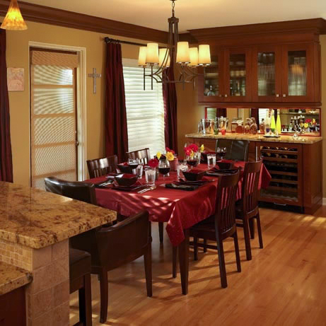  An entertainment buffet is the highlight of the dining area. Matching the kitchen cabinetry for a unified look, the buffet features a wine cooler, two refrigerated drawers and a mirrored back. The doors of the lighted hutch have opaque glass insets that match the laundry room door. A door leads directly to the rear patio. 